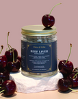 Beef Liver Supplement jar surrounded by fresh cherries, highlighting nutrient-rich benefits for energy and immune support.