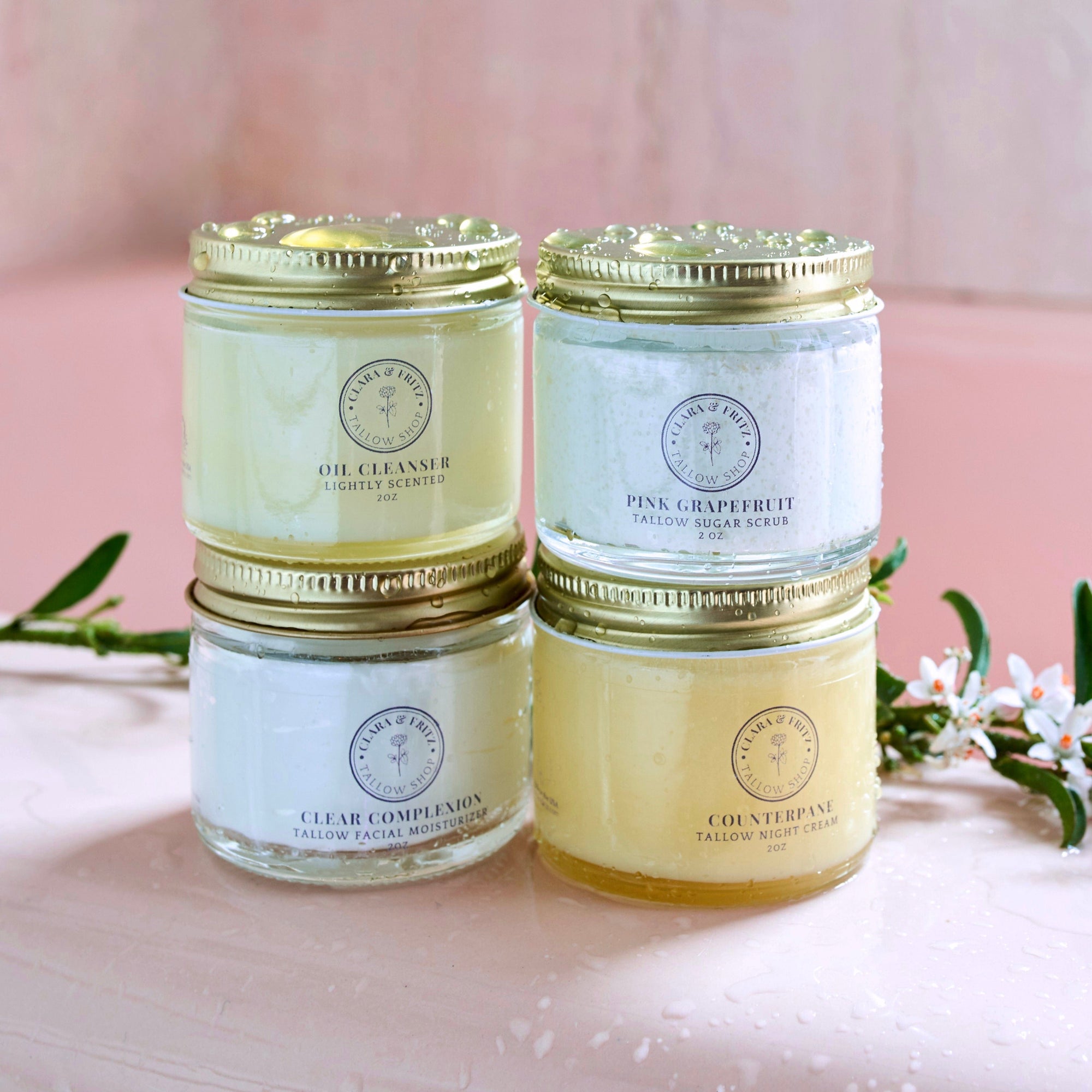 Capsule Skincare Kit featuring four luxurious facial products for a complete tallow facial routine in elegant jars. Includes Pink Grapefruit Tallow Sugar Scrub.