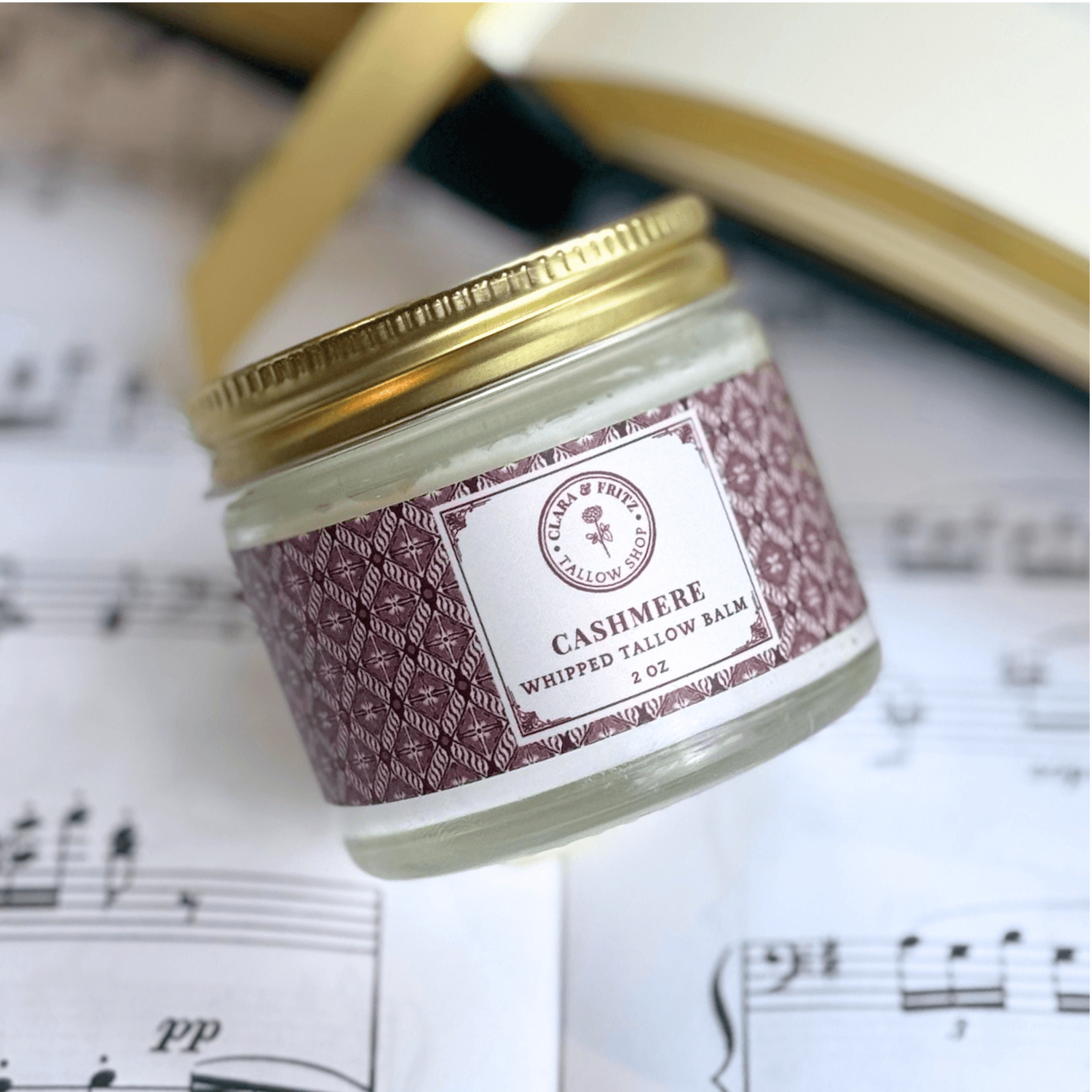 Seasonal Scent Gift Set with Cashmere Whipped Tallow Balm on a music sheet background.