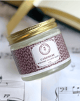 Seasonal Scent Gift Set with Cashmere Whipped Tallow Balm on a music sheet background.