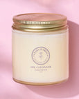 Tallow-Based Oil Cleanser in jar on pink background for balanced skin