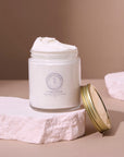 Open jar of Whipped Pure Hydration Set unscented whipped tallow balm on a textured surface, highlighting its creamy texture.