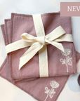 Clover Organic Cotton Washcloth Set of 4 in blush, tied with cream ribbon, featuring embroidered clover design. Perfect for a non-toxic routine.