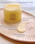 Counterpane Tallow Night Cream jar with ingredients: grass-fed tallow, beeswax, rosehip, frankincense, and lavender oils on a tray.
