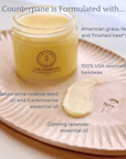 Counterpane Tallow Night Cream jar with ingredients: grass-fed tallow, beeswax, rosehip, frankincense, and lavender oils on a tray.