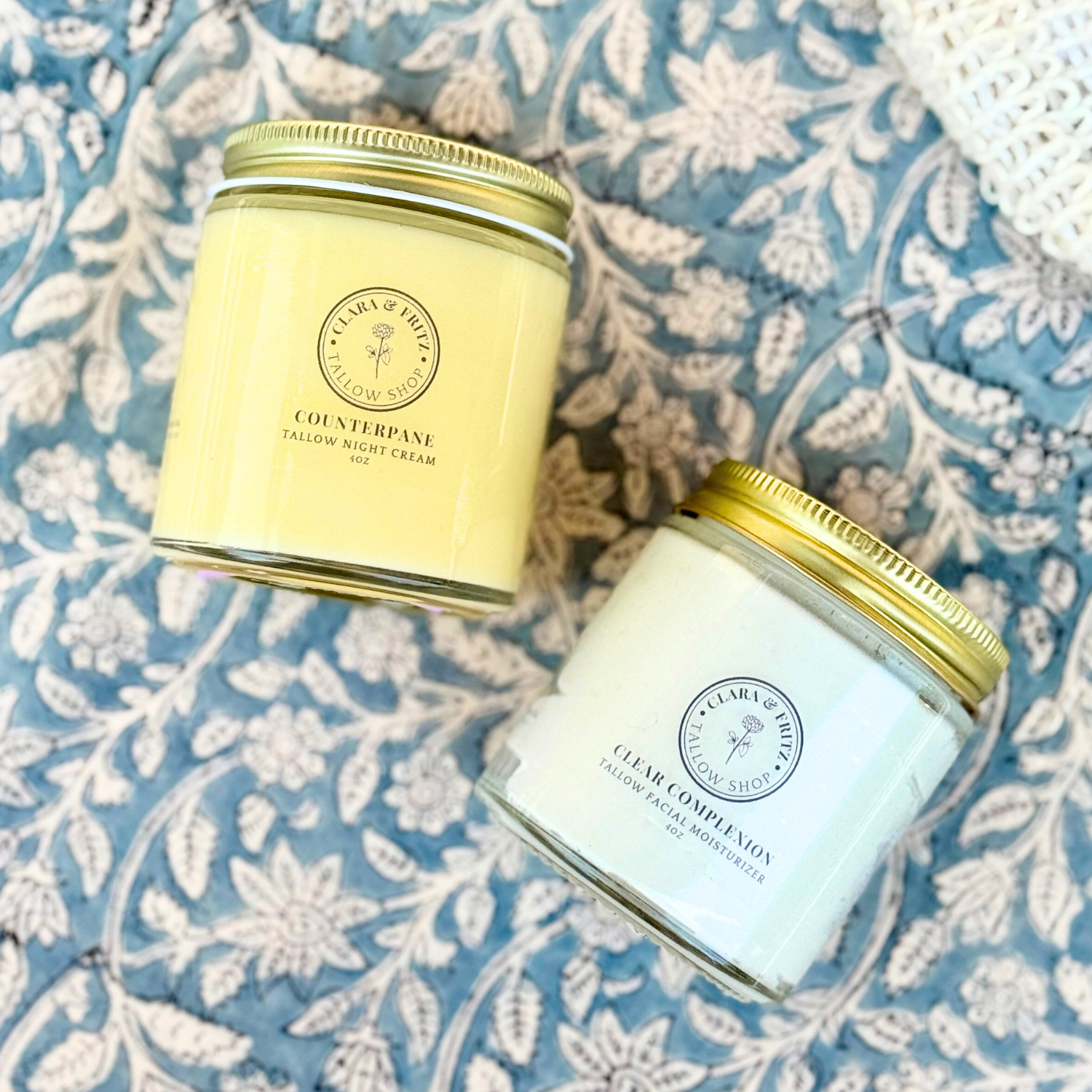 Day & Night Face Moisturizer Duo featuring Counterpane Night Cream and Clear Complexion Day Cream on a floral background.
