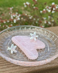 Rose Quartz Gua Sha Tool on plate