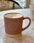 Latte Mug with Clara & Fritz logo on a marble table, perfect for coffee lovers, ceramic mug with matte glaze, ideal gift choice