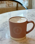 Latte Mug with Clara & Fritz logo on a marble table, perfect gift for coffee lovers.