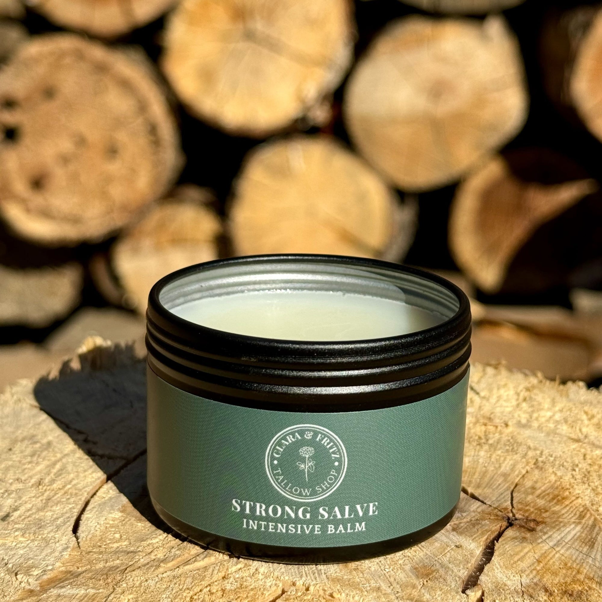 Strong Salve product in front of logs