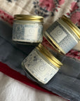 Signature Scent Trio Whipped Moisturizer Set jars on floral cloth background