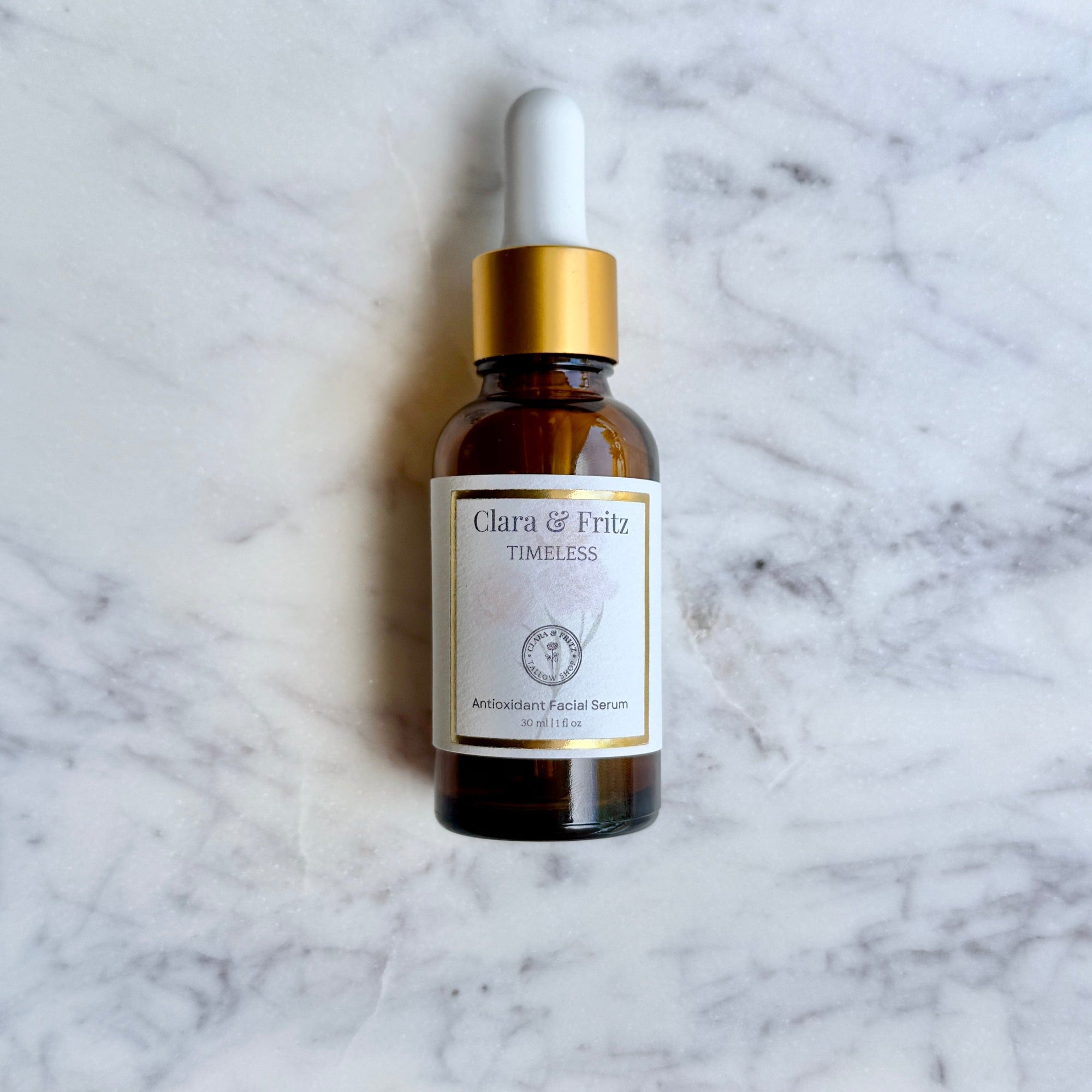 Amber bottle of Timeless Antioxidant Facial Serum on marble background