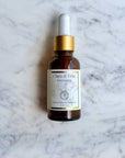 Dropper bottle of Clara & Fritz Radiance serum on a marble background, part of The Complete Facial Skincare Routine.