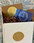 Clara & Fritz Physical Gift Card in a kraft envelope with gold foil label and blue stamp.
