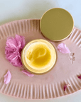 Rose Scented Fragrance Balm with pink petals on a decorative plate.