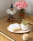 Heirloom Vanity Tray styled with cosmetics, statuette, pink flowers, and wicker surface