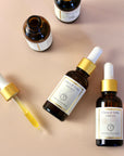 Serenity Calming Facial Serum from The Serum Trio bottles and droppers on a neutral background.