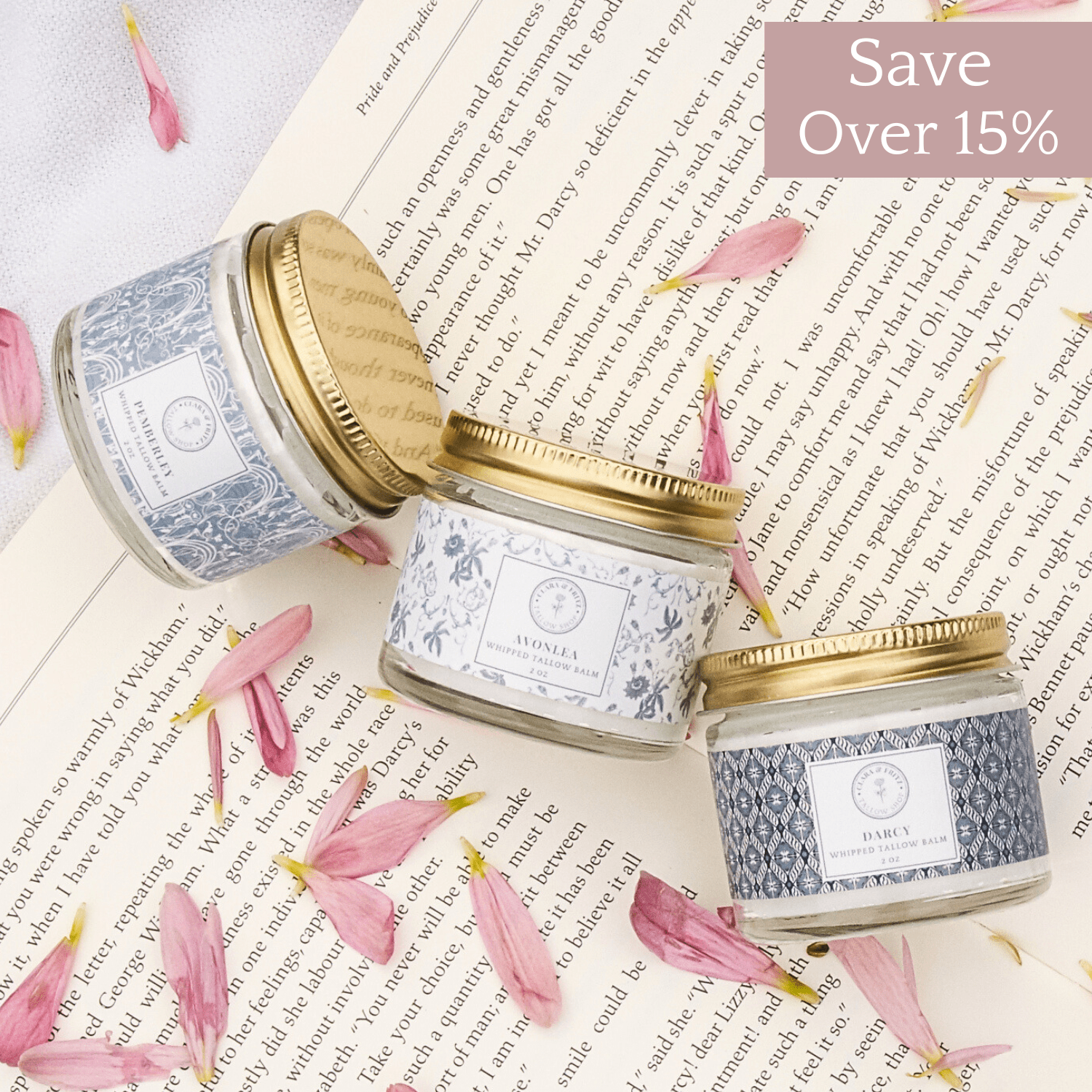 Alt Tag: Signature Scent Trio whipped moisturizer set on an open book with flower petals, showcasing the scents and packaging.