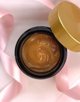 Open jar of Timeless Antioxidant Balm with luxurious gold lid and pink ribbon