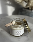 Natural Deodorant in a glass jar, tallow-based and non-toxic, shown on a marble surface.