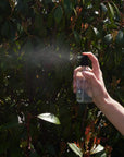 Person spraying Lavender Hydrosol for Facial Use in garden setting