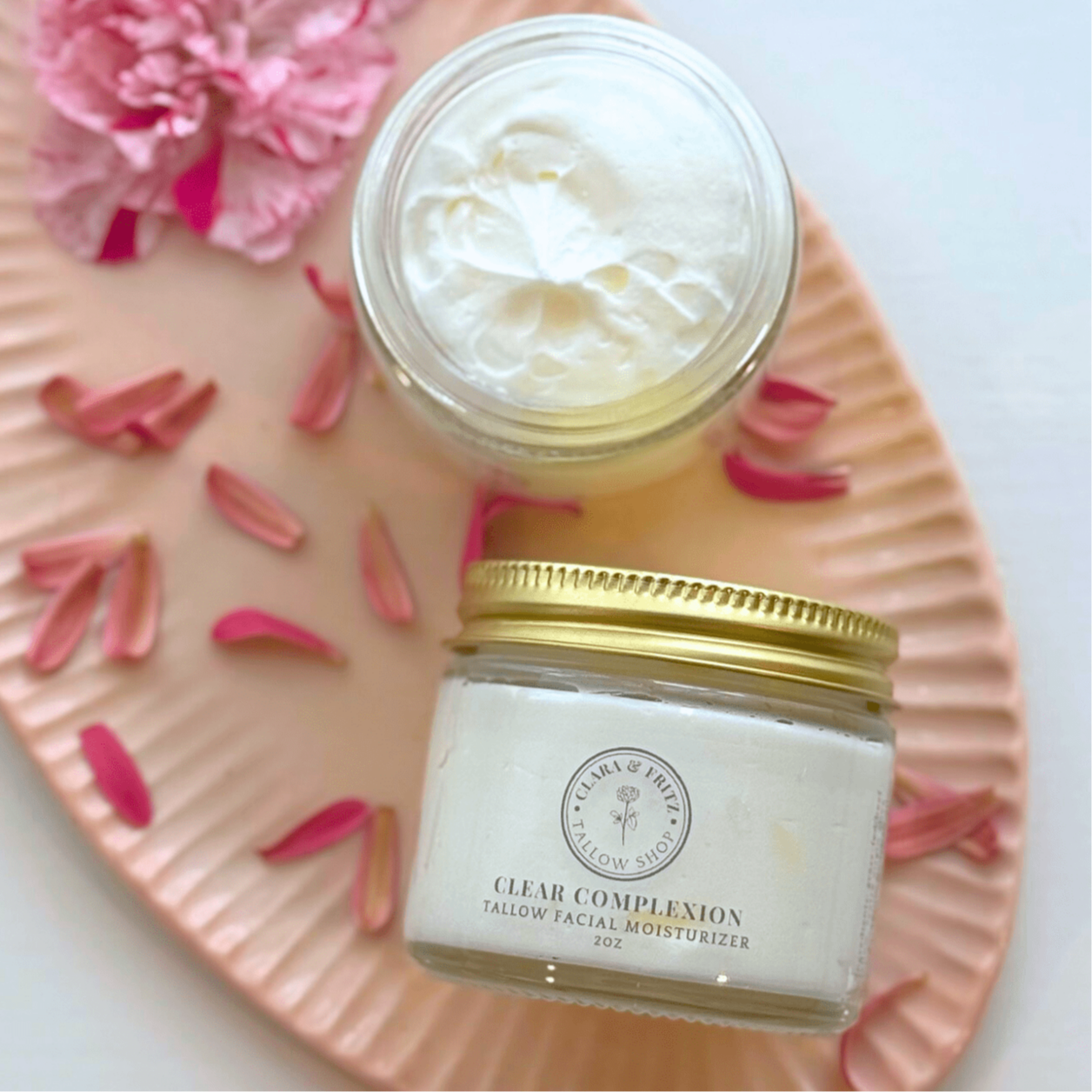 Clear Complexion Whipped Tallow Facial Moisturizer jar and cream on floral pink tray