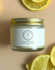 Natural Tallow Deodorant in a glass jar surrounded by lemon slices on a pastel background.