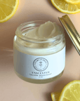 Jar of Natural Tallow Deodorant with lemons on a pink background; aluminum-free and non-toxic