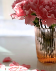 Garden Rose Juice Glass with pink flowers on a sunny table
