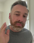man grooming himself with tallow stick and comb