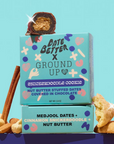 Date Better Snacks Snickerdoodle Cookie, nut butter stuffed dates, vegan and gluten-free, in teal packaging with almonds and cinnamon.