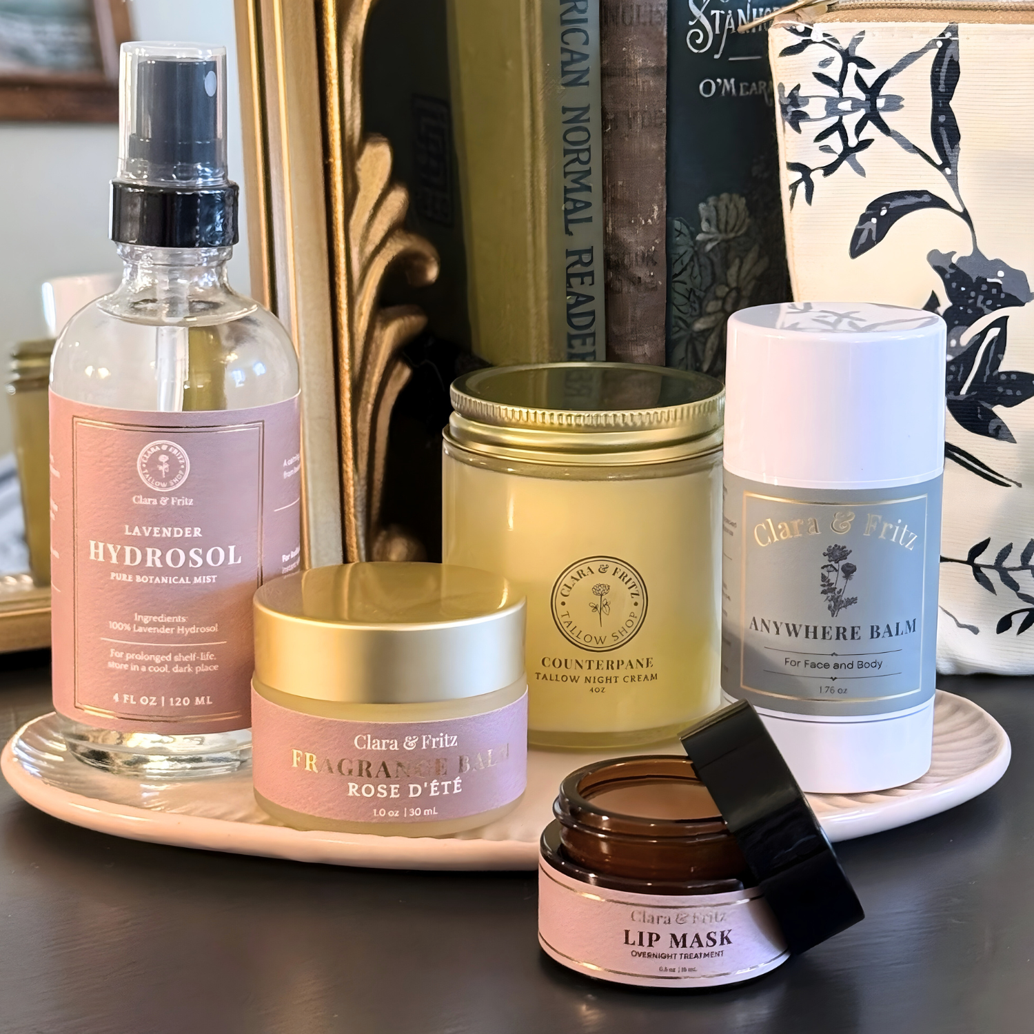 Skincare lineup in front of books