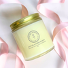 Clear Complexion Solid Moisturizer in a glass jar with gold lid and pink ribbons around