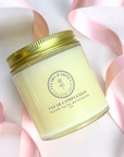 Clear Complexion Solid Moisturizer in a jar with pink ribbon backdrop